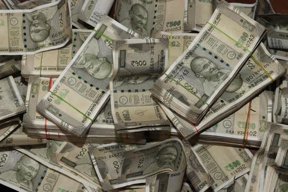 Piles of Indian currency, 500 rupee notes.