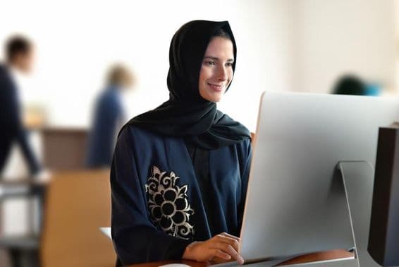 Arab teacher in school wearing abaya and hijab.