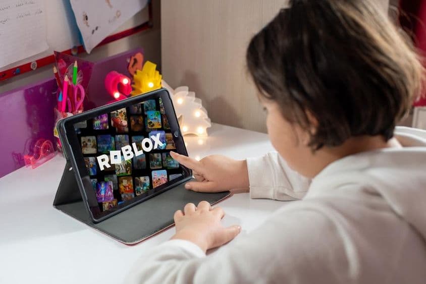 Young girl playing Roblox game.