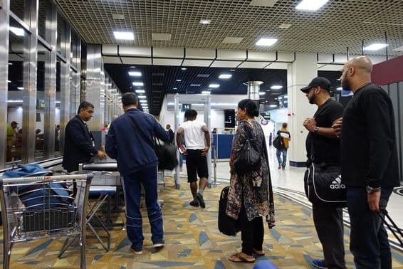 Air travelers pass through security checks at Dubai International Airport.
