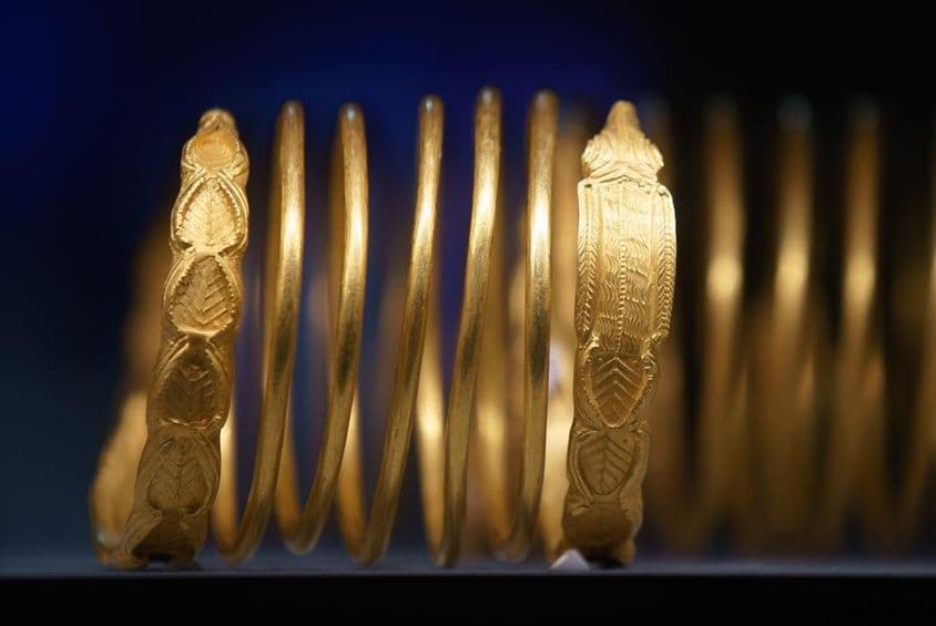 Gold bracelets made of solid gold on display.