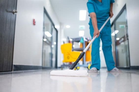 Cleaner mopping the hall floor.