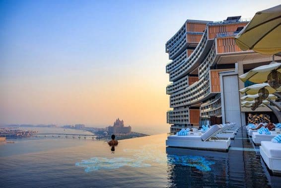 Sunset over an infinity pool with a view of Palm Jumeirah at Atlantis Royal.