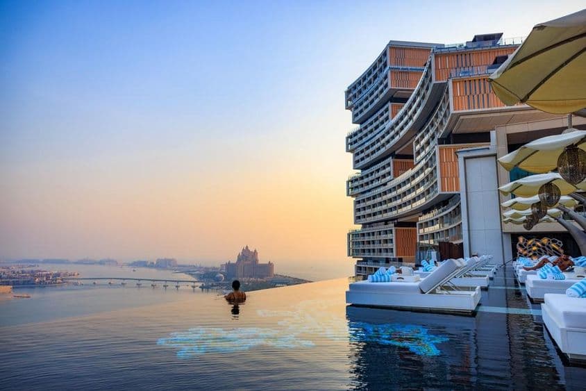 Sunset over an infinity pool with a view of Palm Jumeirah at Atlantis Royal.