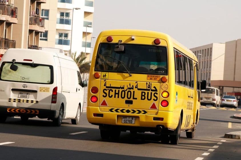 Yellow school bus in Dubai for student transportation.
