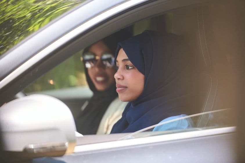Arab female instructor teaching driving.