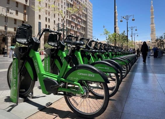A row of Careem bikes at a docking station.