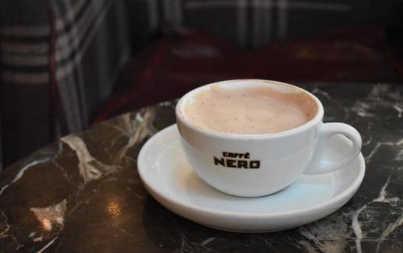 A cup of hot chocolate on a marble table at Caffe Nero.