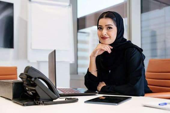 Middle Eastern businesswoman wearing traditional Arab abaya in the office.