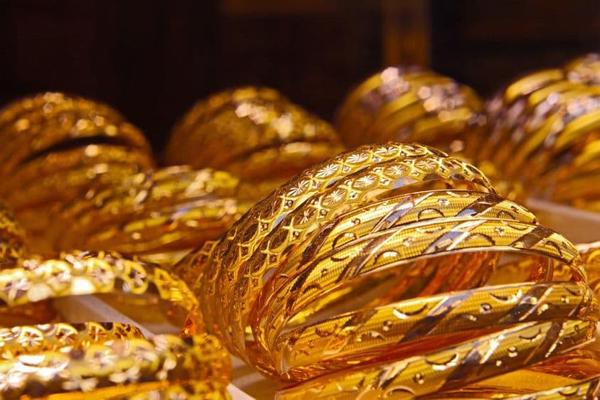 Dubai gold bracelets displayed in a store window.