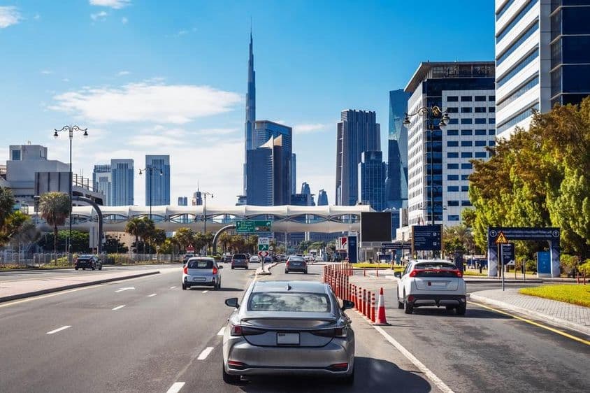 Cars driving on a city street in Dubai.