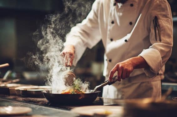 A chef cooking in the kitchen.