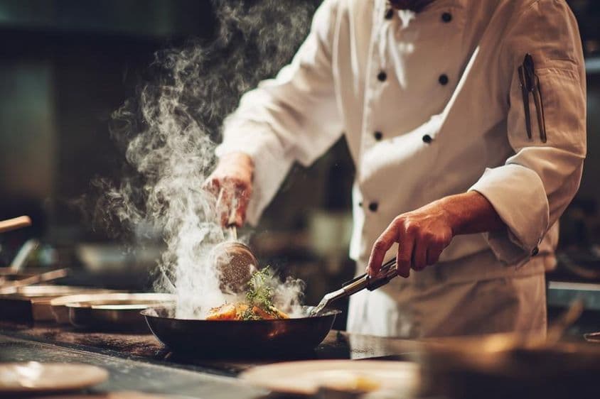 A chef cooking in the kitchen.