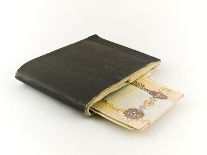 Old checkbook and five dirham banknotes.
