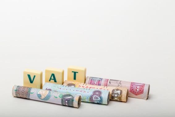 The letters VAT (Value Added Tax) above UAE dirham banknotes.