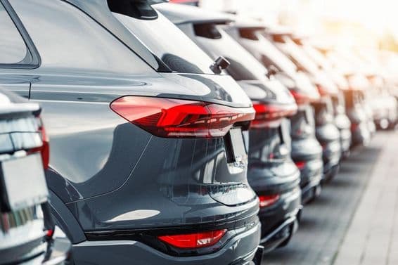 Rear view of many modern new SUV cars in a parking lot.