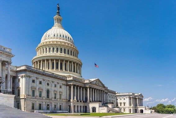 The United States Capitol building with the American flag.