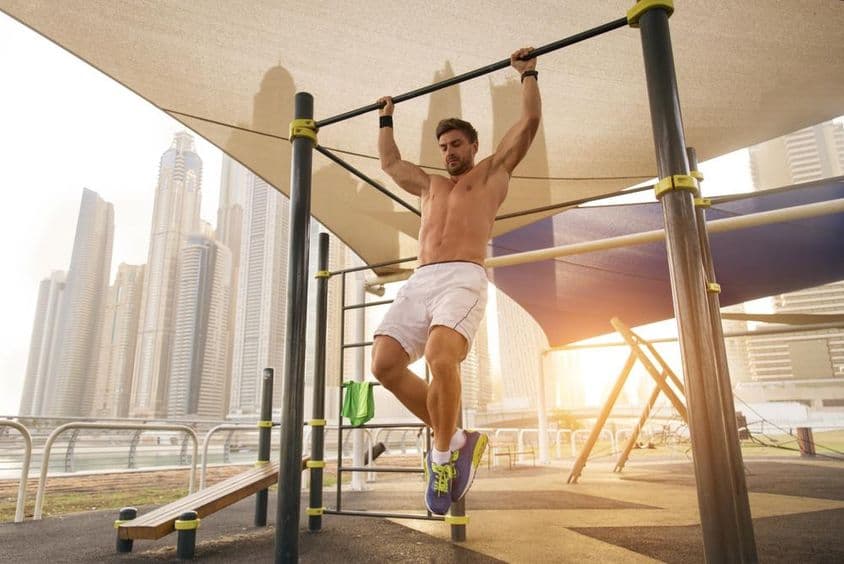 Young athletic man exercising outdoors.
