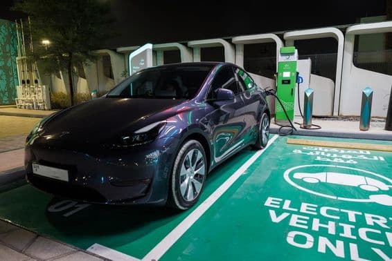 Electric car charging station with power cable at ENOC gas station.