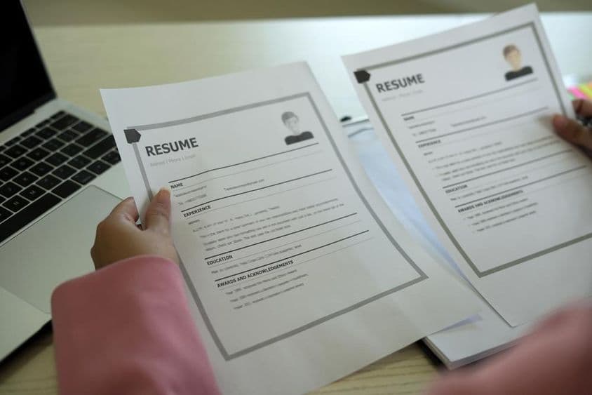 A young Asian female HR manager reading a resume.