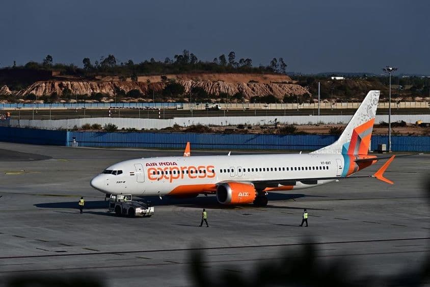 An Air India Express airplane taxiing on the runway.