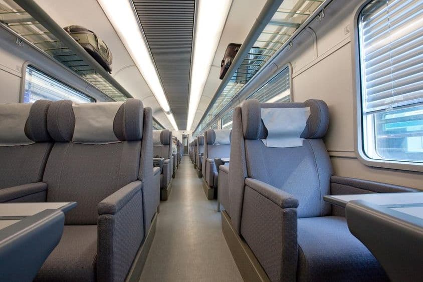 An empty first-class cabin in a modern European train car.