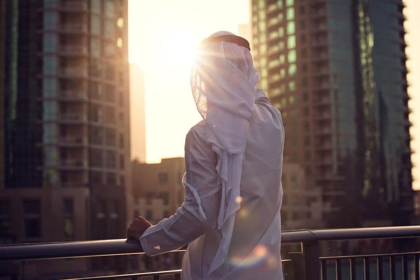 Arab man watching the sunset in Dubai.