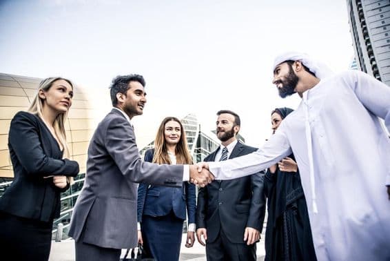 Arab and Western businessmen discussing work.