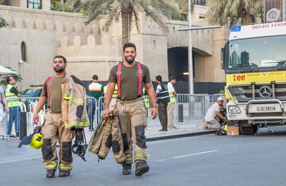 Firefighters walking away from the Address Burj Downtown Dubai building.