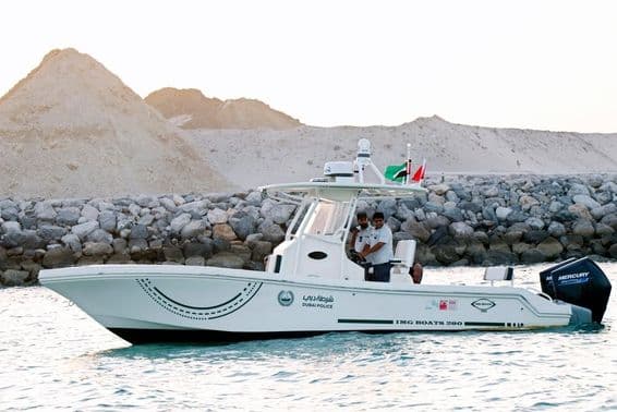 Police officers in a motorboat along Dubai's shoreline.
