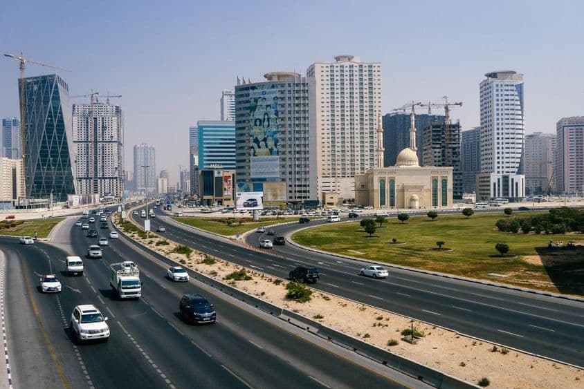 View of Dubai city and highway with many cars.