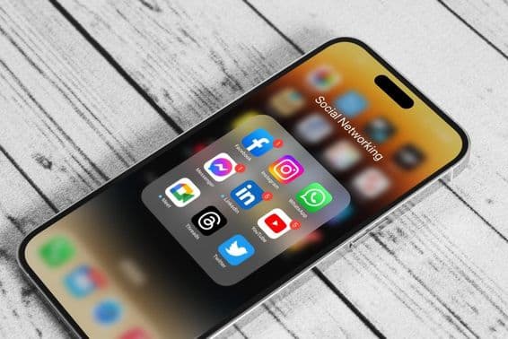 Social media app icon logos on an Apple iPhone 14 Pro Max.