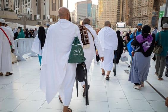 Umrah pilgrims walking near the Grand Mosque in Mecca.