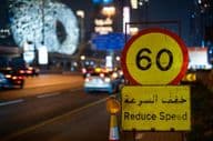 Dubai highway at night with maximum speed limit.