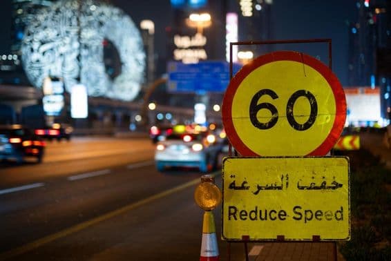 Dubai highway at night with maximum speed limit.