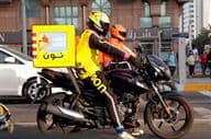 Motorcycle courier delivering in Dubai street.