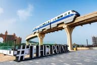 Train traverses above The Pointe waterfront dining and entertainment destination.