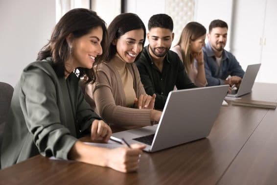 Colleagues analyzing a startup online.