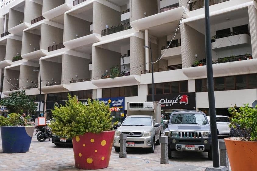 Facade of a modern residential building with large two-story balconies, UAE.