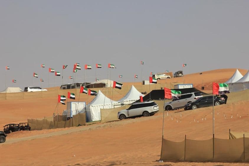 Off-road vehicles and wild camping on massive sand dunes.