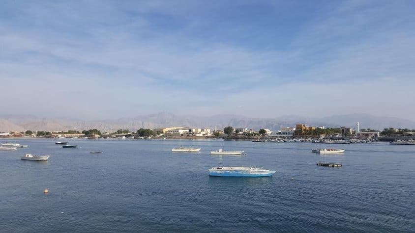 Ras Al Khaimah Bay with blue sea and cloudy sky.