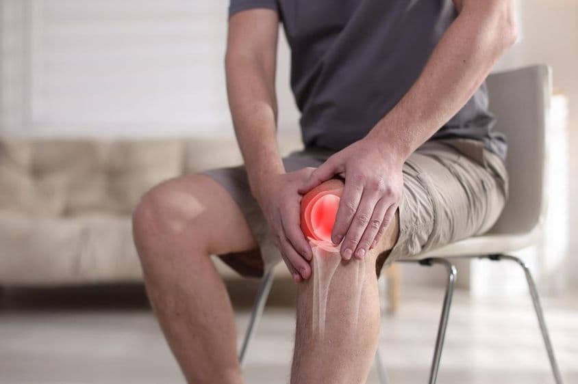 Man suffering from knee pain.
