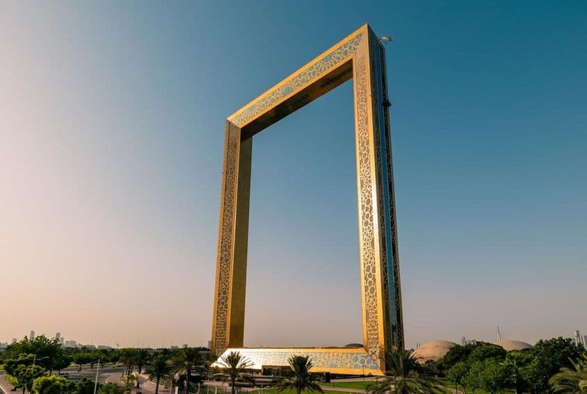 Dubai Frame golden tower building at sunrise.