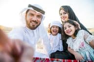 Happy family enjoying a wonderful day in the desert having a picnic.