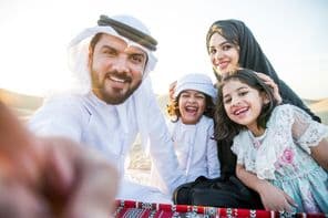 Happy family enjoying a wonderful day in the desert having a picnic.