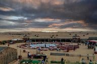 Sunset over a Bedouin camp following traditional desert safaris in Dubai.