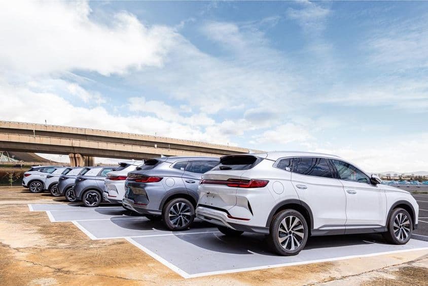 Fleet of modern cars in dealership parking lot.