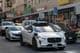 Waymo robotaxi navigating the busy, narrow streets of San Francisco's Chinatown.