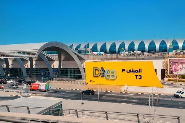 Entrance to the modern Dubai DXB airport terminal.