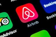 Airbnb app icon on Apple iPhone X screen.
